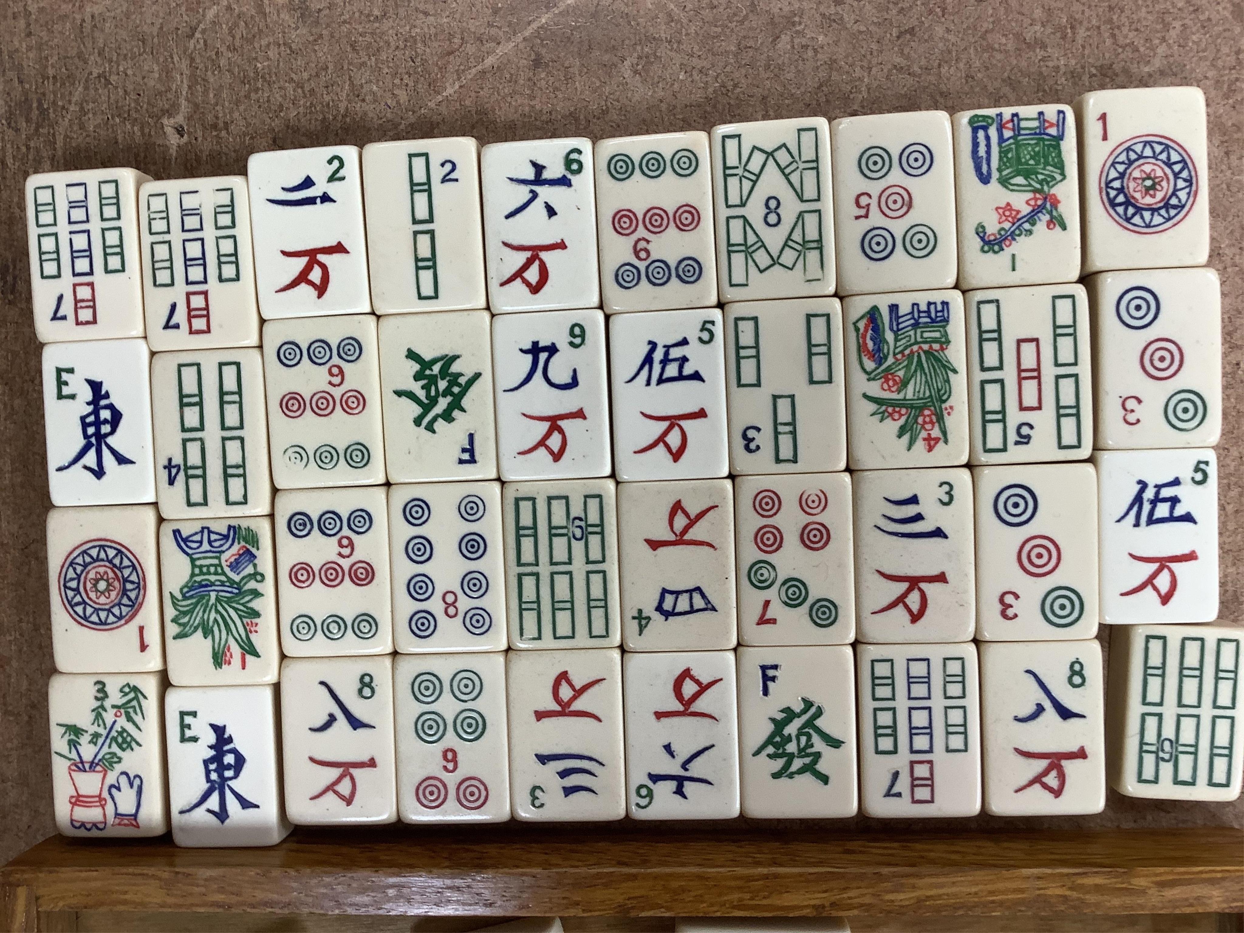 A Chinese carved small camphor box and an oak cased Mahjong set, camphor box 31cm wide x 17cm high. Condition - fair